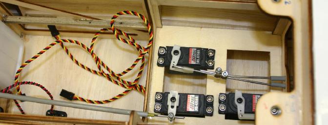 My single servo was connected to the two elevator push rods by connecting the two together with a pair of wheel collars.  I preferred to use the collars to get the elevator halves centered to begin with, and then wrap some copper wire around the joint and