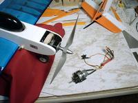 Name: 01010021.jpg
Views: 306
Size: 64.0 KB
Description: E-flite 480 outrunner installed, original motor and gearbox on the bench for comparison.