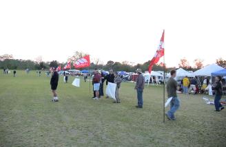 Models being flown as the sun sets behind the field