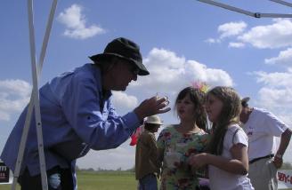 A magician entertains some of the younger attendees