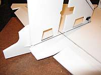 Name: b3.jpg
Views: 2697
Size: 45.2 KB
Description: Complete rudder servo installation.  Note the pushrod guide next to the prop slot.  The servo is mounted on the forward edge of the fin to help with balancing the plane.
