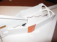 Name: b5.jpg
Views: 2531
Size: 37.8 KB
Description: Install the fuselage sides.  A piece of packing tape holds the pieces together until the glue sets.  Note the slot for the rudder pushrod.