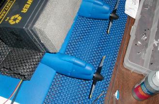Holding the motors in place while the adhesive cures.