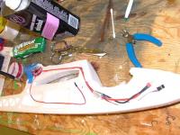 Name: DSCF2244.jpg
Views: 8008
Size: 95.4 KB
Description: The 3rd wire is routed using the lower channel. The upper channel would have to be made deeper to run all 3 wires.  I have the end of the wire taped and ready for the brushless upgrade.  Use good grade RC motor wire from Cheapbatterypacks.com