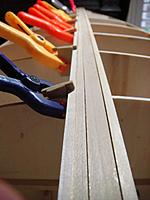 Name: DSC01462.jpg
Views: 113
Size: 46.9 KB
Description: Adding bottom planks with ho'made plank holders. The sand paper glued on the side of the hulder makes it stay in place when clamped to a shadow form.