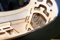 Name: Kyosho P40-50 series build mods 008.jpg
Views: 158
Size: 52.5 KB
Description: Looking thru second bulkhead you can see motor box side frames with round hole. I will be adding 1/8 ply over the entire box frame and epoxing.