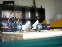 Name: servos.jpg
Views: 146
Size: 43.5 KB
Description: Some household tape around the servos and then double sided tape to mount the servos. More than strong enough and assures easy removing when necessary :)