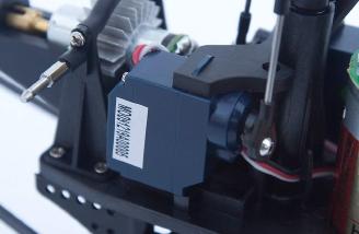 The servos are held tightly between the plastic frame.