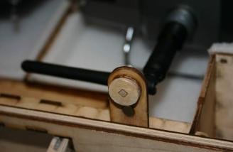 This is one of two latch buttons. You can see the larger magnet that is attracted by the one in the lid. The small opposing ones are just below this one.