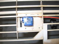 Name: 38l.jpg
Views: 162
Size: 66.0 KB
Description: The Servo hatch is screwed into the wing.  The Upper Rear spar was cut to accommodate the servo. I also cut off part of the servo frame to fit the servo onto the hatch.