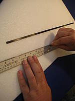 Name: 074.jpg
Views: 437
Size: 50.5 KB
Description: Cut a slit 4.5" back from the nose of the plane with a razor blade.  CA glue the spar into the wing.