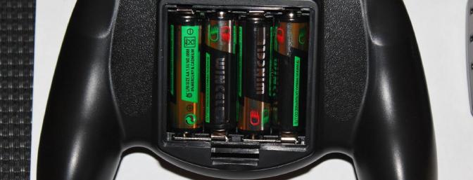 The 4-included AA Alkaline batteries installed in the back of the transmitter.