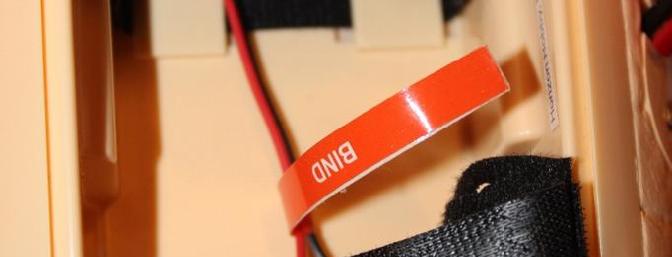The binding extension wire is in the battery compartment in the front underside of the plane.