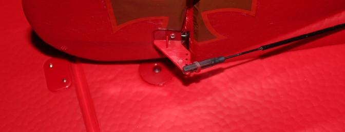 The one bolt that secures the horizontal stabilizer can be partially seen under the rudder.