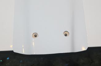 The belly pan with the holes properly opened to let the washers through to the bolt plate.