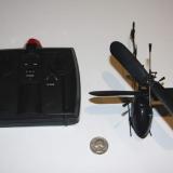 The transmitter and my Black Stealth with a quarter for a size comparison