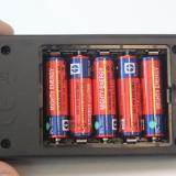 The five supplied AA batteries installed in the charger.