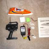 Every thing that comes with the Reef Racer: boat, battery, charger, transmitter, instructions, two extra fuses and a spare prop.