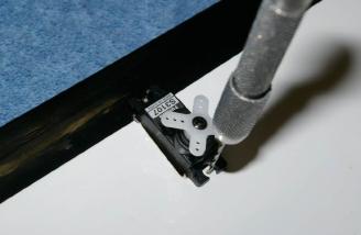 A small pilot hole helps prevent splitting the wood when installing the aileron servos.