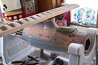 Name: I built a rather skookum balsa saddle for the wing, here I am doing a trial run on fitting plast.jpg
Views: 147
Size: 183.0 KB
Description: The wing mount uses 4 nylon screws to hold the wing in place. Seems to be very strong.