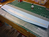 Name: P1010426.jpg
Views: 53
Size: 234.4 KB
Description: The wing will be 3 layers of FFF laminated. Here is the center section. Relief cuts for the dihedral, 1/4" balsa spar CAed in place covered with a strips of reinforced packing tape on both sides.