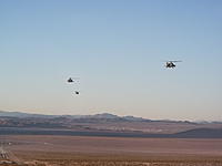 Name: DSCF3162.jpg
Views: 102
Size: 72.4 KB
Description: A pair of Apaches with a Blackhawk in trail formation pass over my HMMWV the next morning...