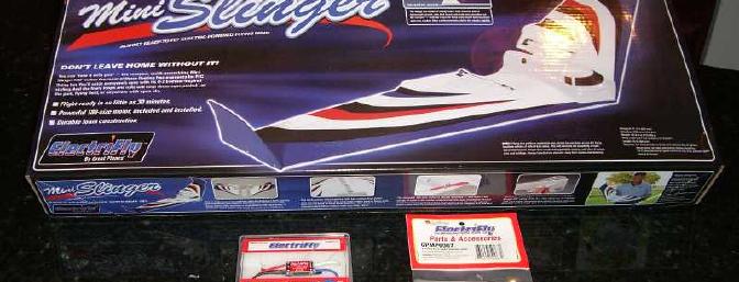 The complete kit contents, including the 2 wing halves and carbon wing rods, wing tips and plastic bocy, preinstalled 180-class can motor with JST connector, and 2 propellers.