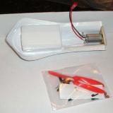 The underside of the body shows the factory installed motor and double sided tape. Propellers and other accessories are in the bag. The body and skid were then stuck to the model using the pre-installed double-sided tape.