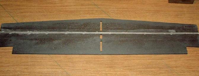 I used epoxy mixed with plenty of lightweight filler to capture the carbon fiber spar in the wing. 