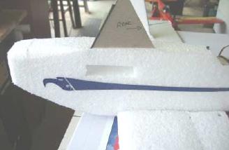 Using the jig to insert a cabine strut into the fuselage.