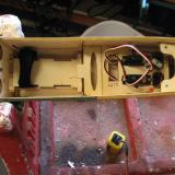 The plywood part with the elongated oval hole is a mount for the receiver.