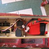 The large 3000 mAh battery slides into the nose. You have to undo two bolts and take the wing off if you want to get to it.