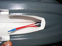 Name: DSCF4021.jpg
Views: 201
Size: 61.5 KB
Description: I taped the ends together to make it easier to pass the wires through the back of the cockpit. Also cut this access hole.