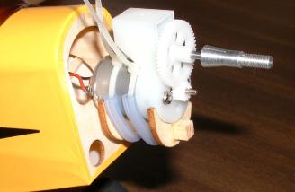 The pre-assembled motor/gearbox assembly was retained in a plywood cradle using a a pair of nylon wire ties.  The ties are sleeved with rubber tubing before fitting.