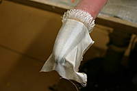 Name: IMG_5288.jpg
Views: 233
Size: 41.1 KB
Description: First layer of 3 oz. crowsfoot fiberglass with 3M 77 adhesive adhere to the tube assembly and over th skeg, no glue yet.