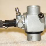 The two needle, cinch mount carb mounts either right or left.
