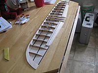 Name: IMG_1179.jpg
Views: 158
Size: 242.1 KB
Description: Looks like a wing.  Ailerons cut...#1 rib and carbon strips in.