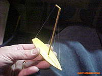 Name: VictorV32Micro17.jpg
Views: 43
Size: 51.5 KB
Description: If you let the light hit it just right, you can see all the stays.  They were CA'd to the hull and then stretched just a wee bit to the other attachment point.