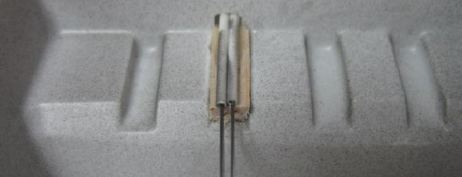  Here the pushrod tubes enter the radio area.  A small scrap of balsa was used to secure the ends of the tubes.  DO NOT omit gluing the ends of the pushrod tubes in place.  They must be attached for proper elevator function.  