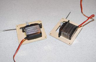 The servos were then glued right to the hatches.  This method is very secure and has worked well for me on past airplanes.  The glue surface area is large, but use a good quality 30 minute epoxy here. If later desired or needed, the servos can be removed by cutting the tape!