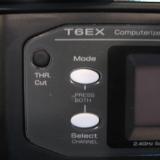 Mode and select buttons. Simply press and hold both to enter the program mode. Turn on the TX, then select your model number!