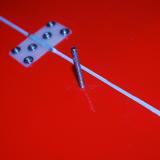 The screw goes completely through the flap surface.