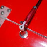 The aluminum joiner and tiny aircraft nut and bolt combo make a secure connection to the flaps.
