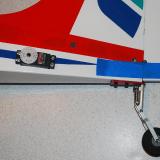 The rudder was added to the fin and tape was used to secure everything.  The factory hole for the tail-wheel was not aligned and I had to re-drill a new hole in the rudder.