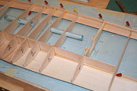 Name: IMG_0028.jpg
Views: 51
Size: 146.4 KB
Description: All the rib bit thingies are in around the centreline and I've started in on the spar webbing. So far, the wing's not moved on the bench.