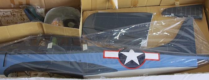 The complete kit contents, including painted pilots, guns and a fiberglass cowl.