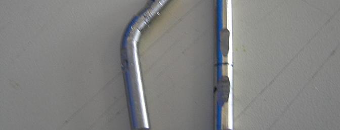 The original steel pin is on the left, replacement pin on the right.