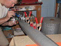 Name: DSCN0187.jpg
Views: 1087
Size: 87.8 KB
Description: Pouring on the liquid cement along the keel union between left and right hull halves. Note the use of clamps to hold things together till the weld is fast.