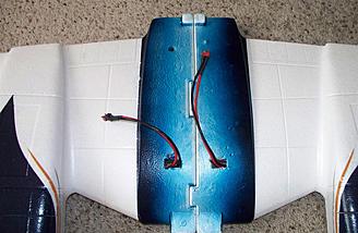 Looking at the other side of the wing shows the battery leads for each ESC poking through.  The blue stripe down the center looks as if it's incomplete, but only the outer edges show once the wing is installed.